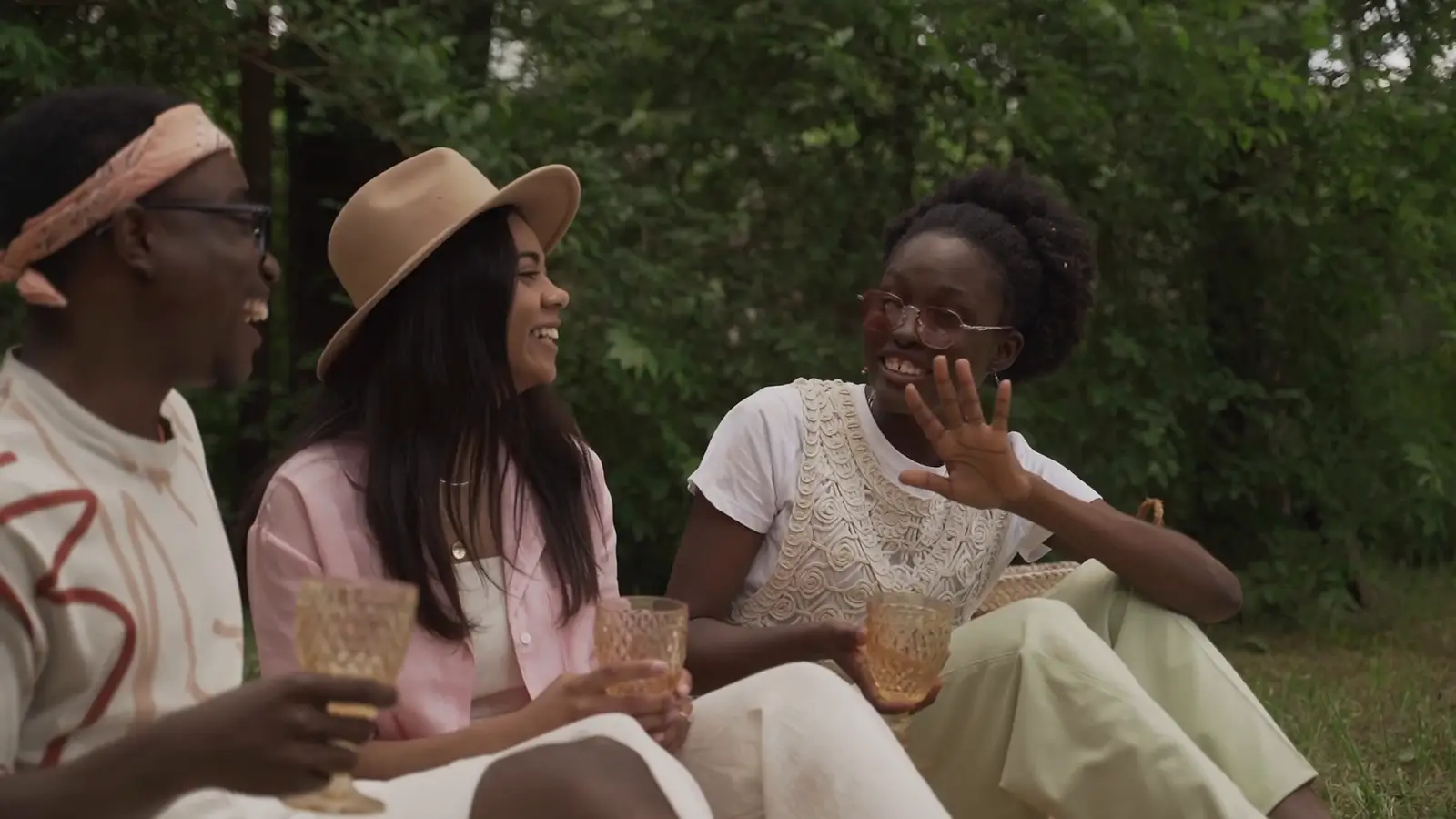 Friends talking and laughing at an outdoor picnic