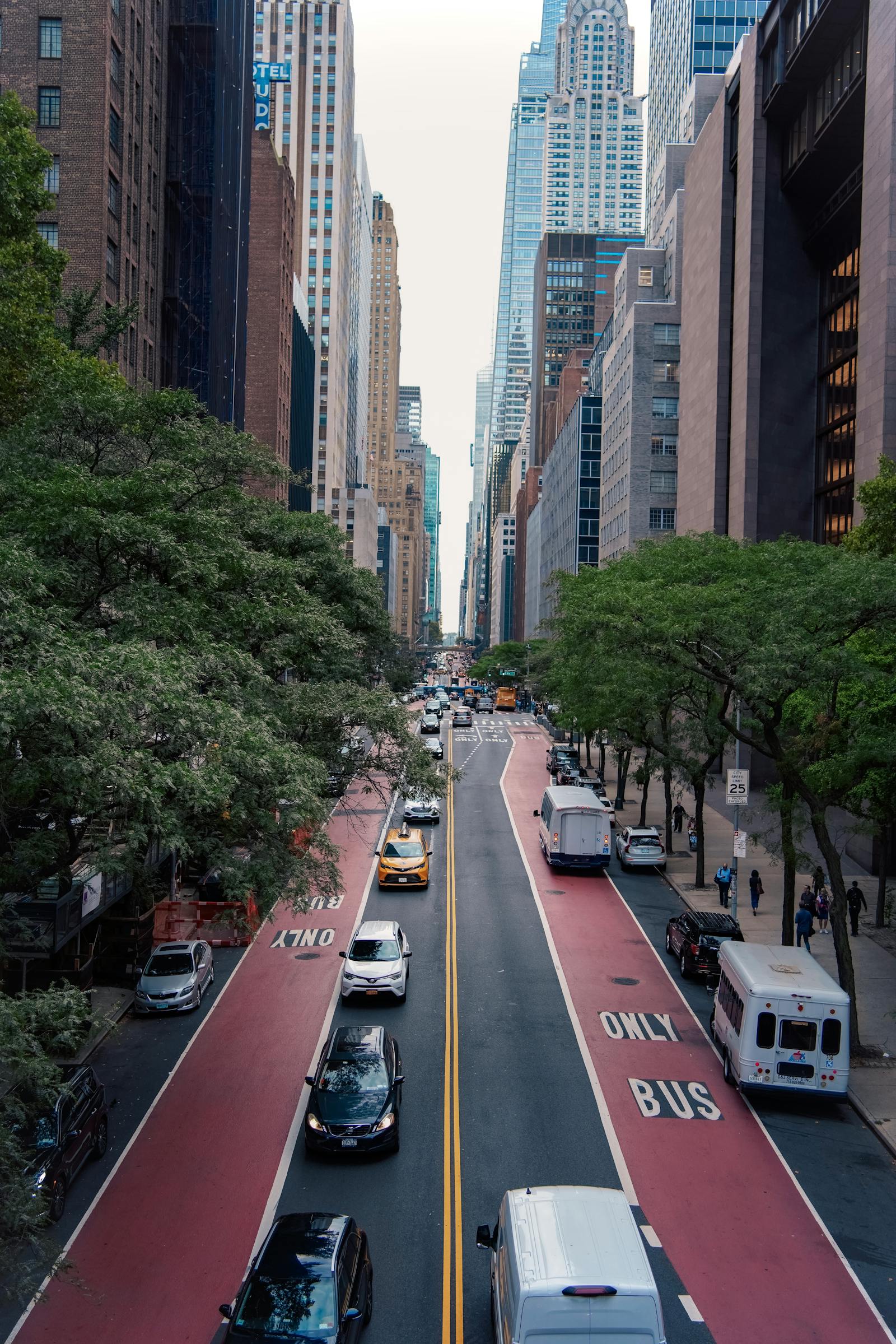 A vibrant New York City street scene with skyscrapers and busy traffic.