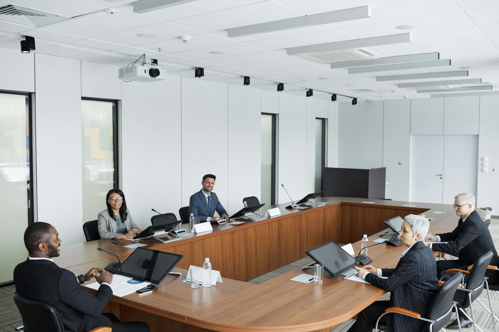 A multicultural group of professionals in a modern conference room meeting.